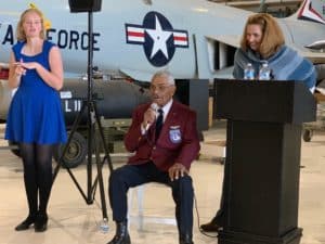 Frank Macon and Liz Harper speaking in front of an Air Force jet